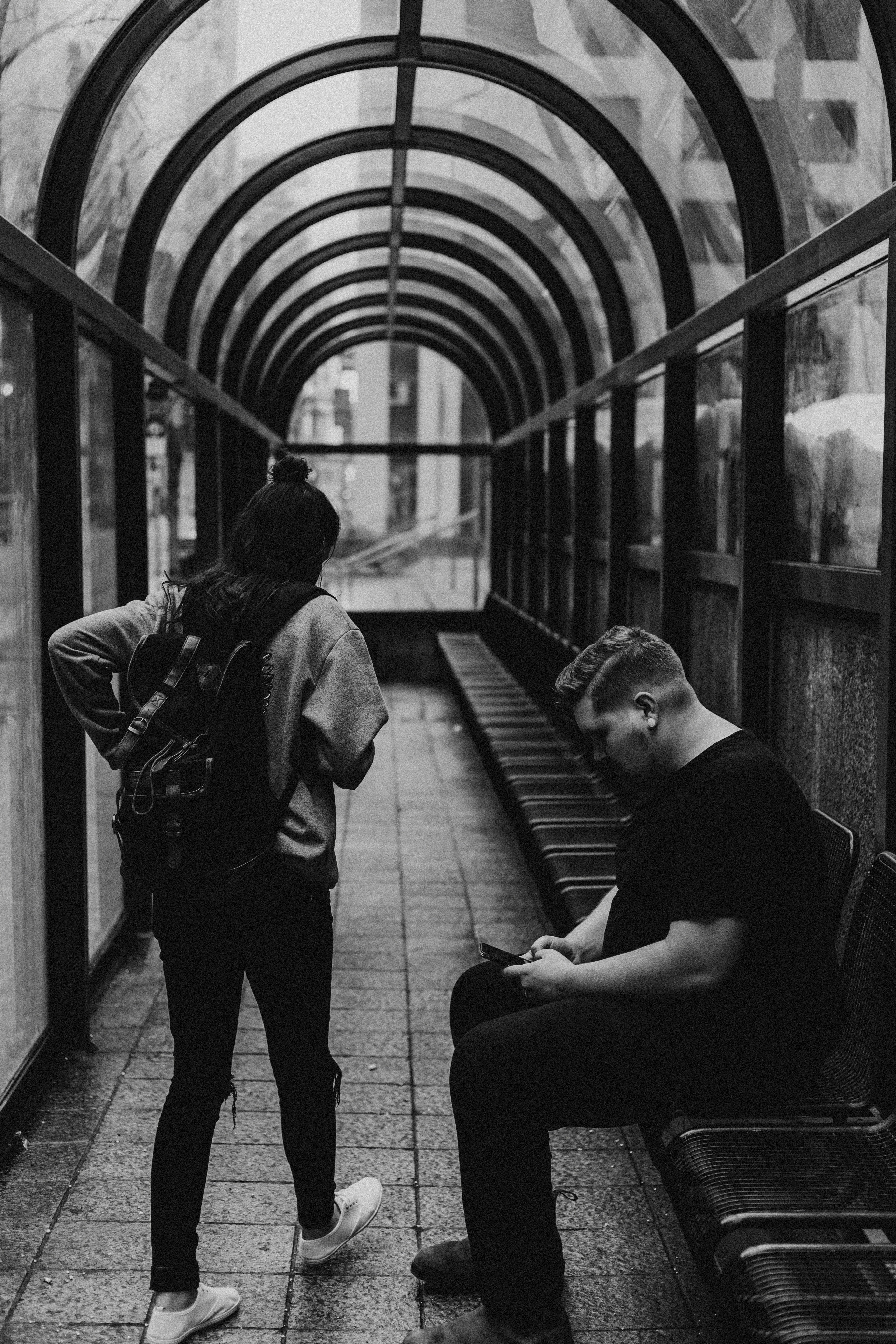 grayscale photo of man and woman inside room